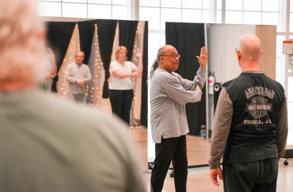 A Tai Chi instructor teaches a class at The Pavilion at Fort Steilaccom Park.