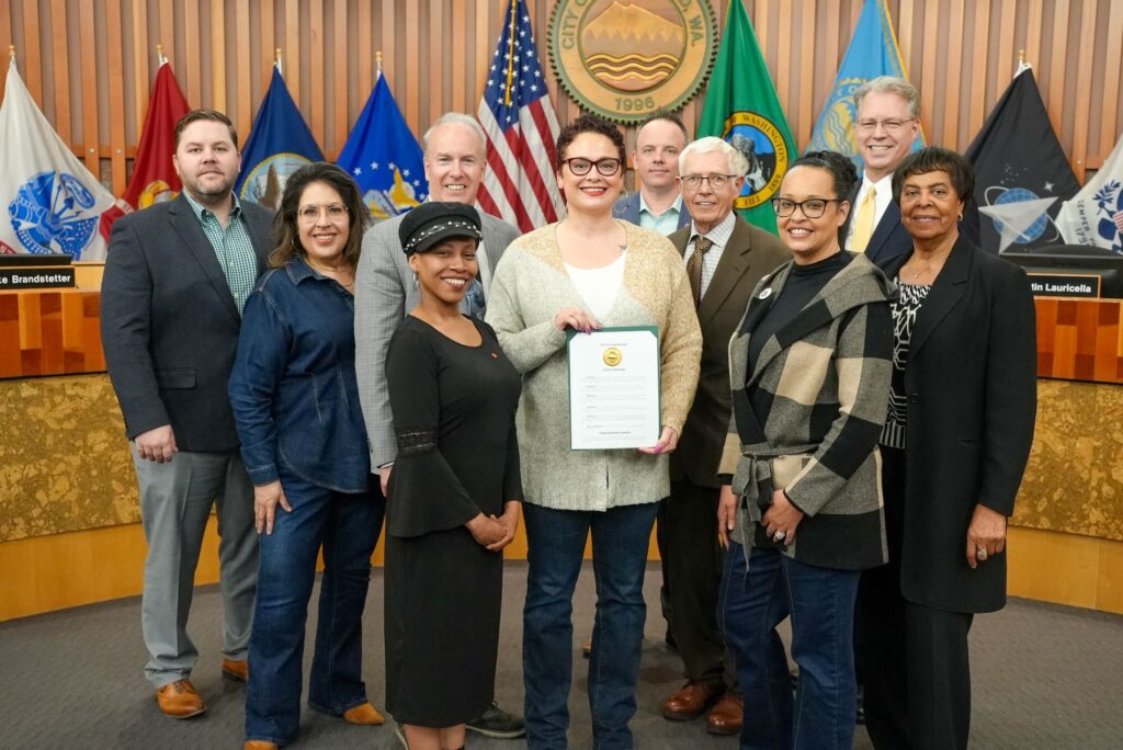 The Lakewood City Council pose for a photo in Council Chambers with representatives from the Realtors Association to recognize April 2025 as Fair Housing Month.