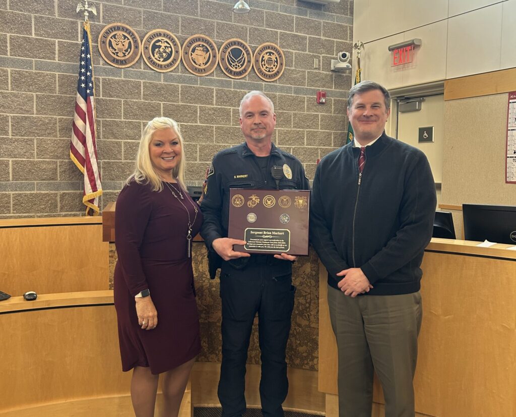 Lakewood Municipal Court Judge Tim Lewis and Court Administrator Deana Wright stand with Lakewood Police Department Sgt. Brian Markert.