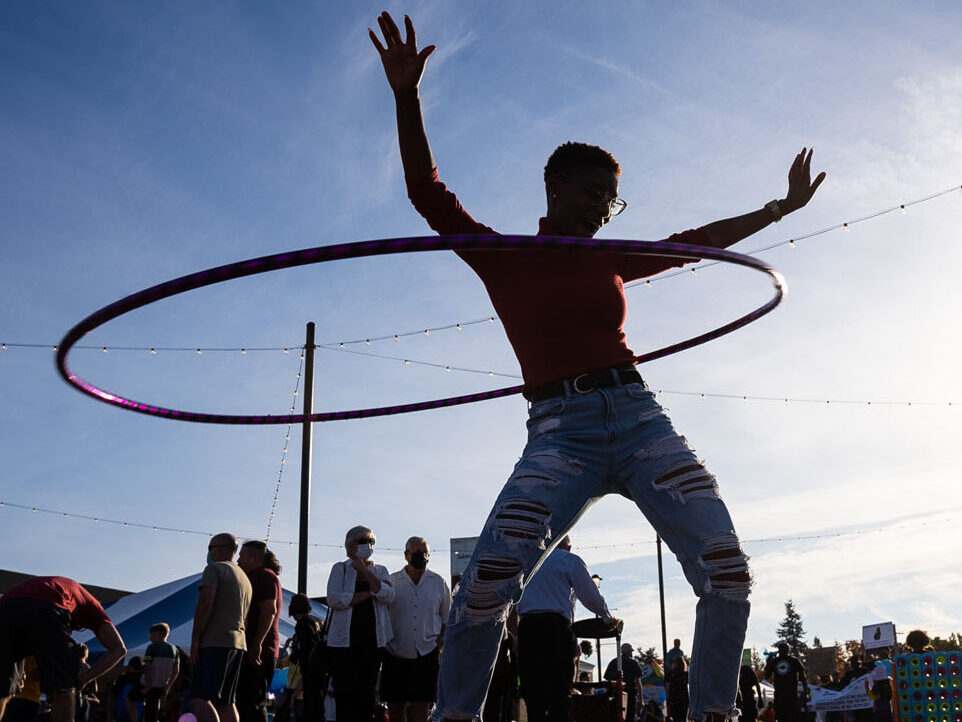 A silhouette of a person with a hula hoop against a blue sky in Lakewood, WA.