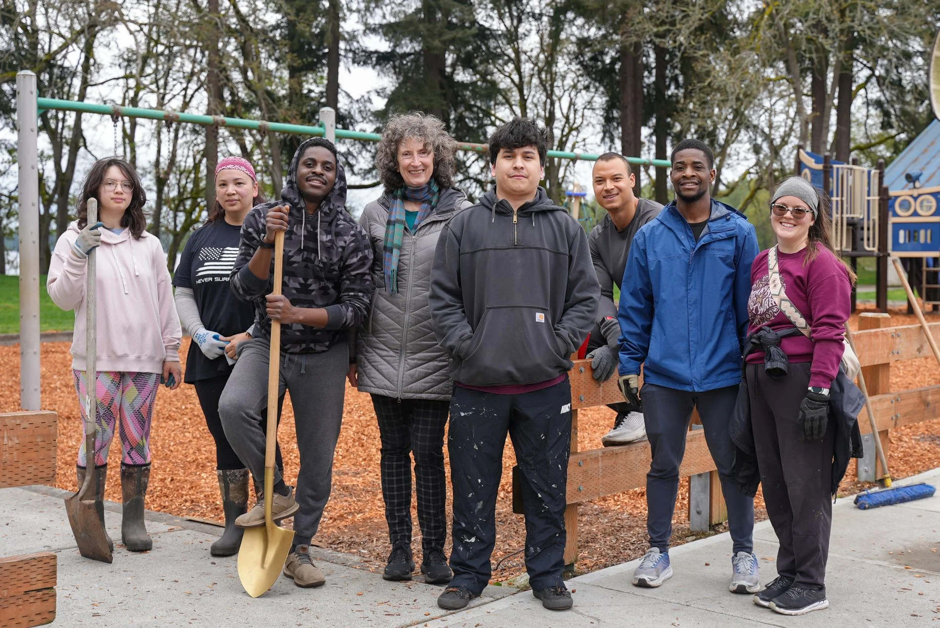 A group of volunteers stand together and smile at the camera at the City of Lakewood Park Appreciation Day in April 2024.